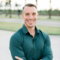 a-man-in-a-green-shirt-is-posing-for-a-picture.jpg a man in a green shirt is posing for a picture